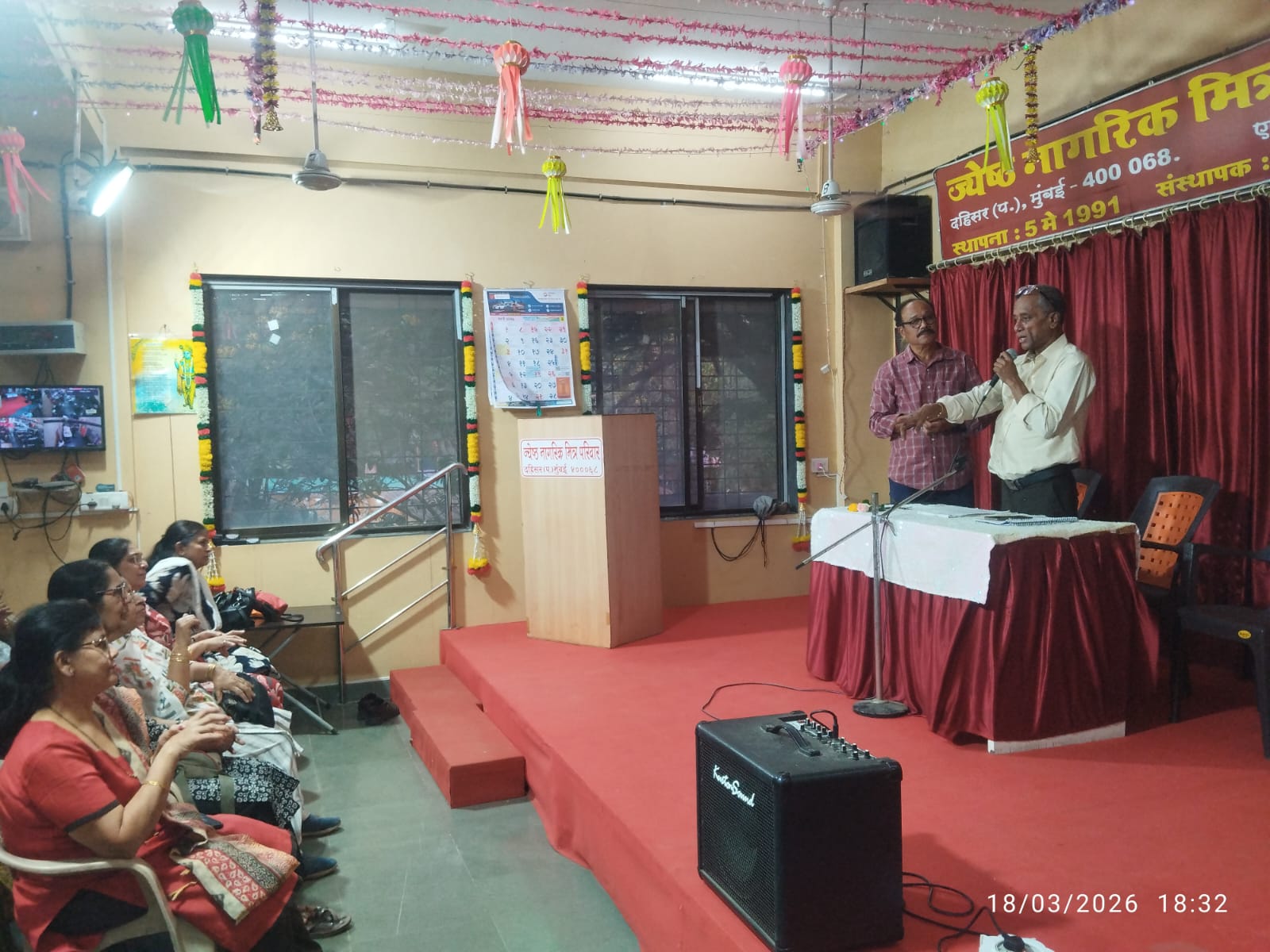 Speaking on stage at seminar